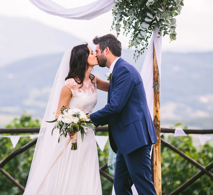 Outdoor Wedding Ceremony | Bride in Naomi Neoh | Groom in French Connection Suit