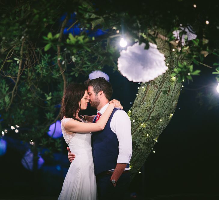 Bride Naomi Neoh Gown & Groom in French Connection Suit under Festoon Lights