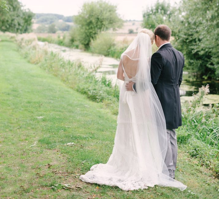 Bride in Charlie Brear Peyton Dress & Augustine Skirt & Groom in Traditional Morning Suit