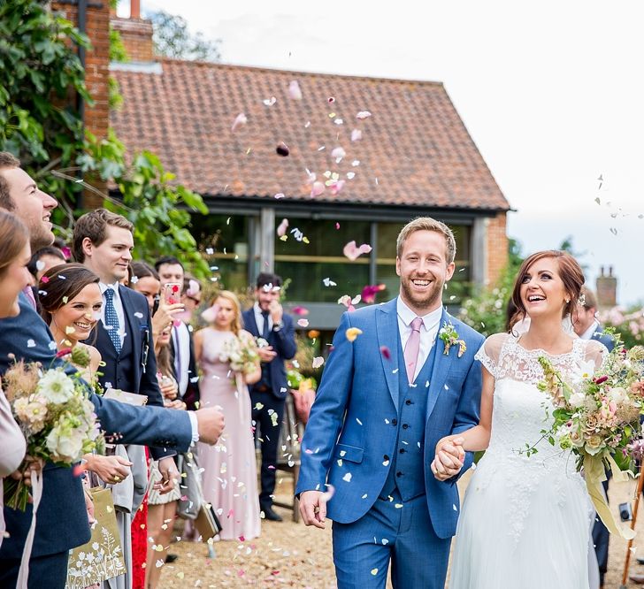 Confetti Shot with Bride in Infanta Wedding Dress & Groom in Blue French Connection Suit