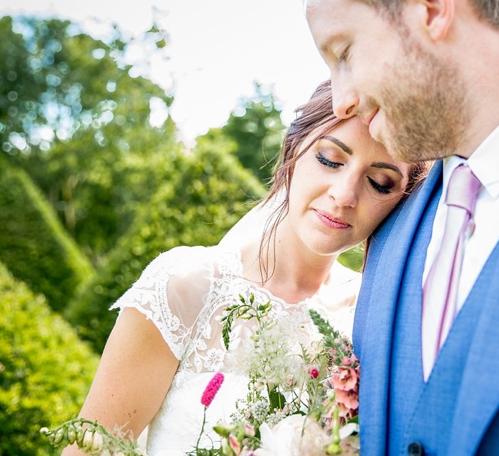 Bride in Raimon Bundo Infanta Wedding Dress & Groom in Blue French Connection Suit