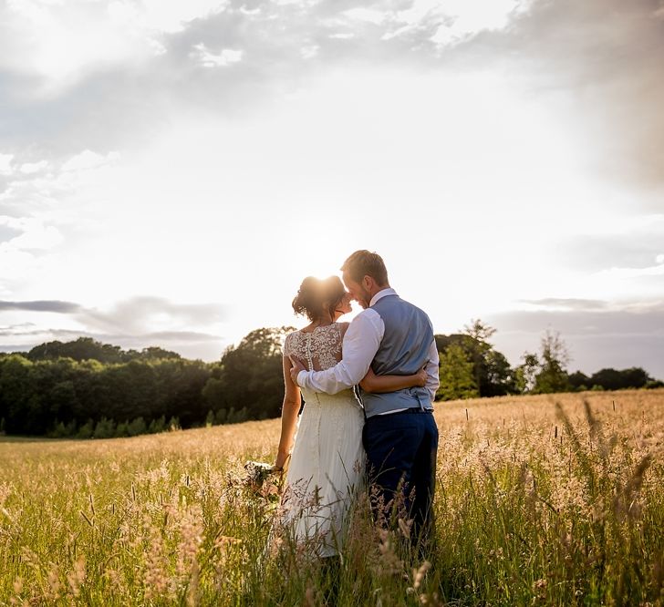 Bride in Infanta Wedding Dress & Groom in Blue French Connection Suit