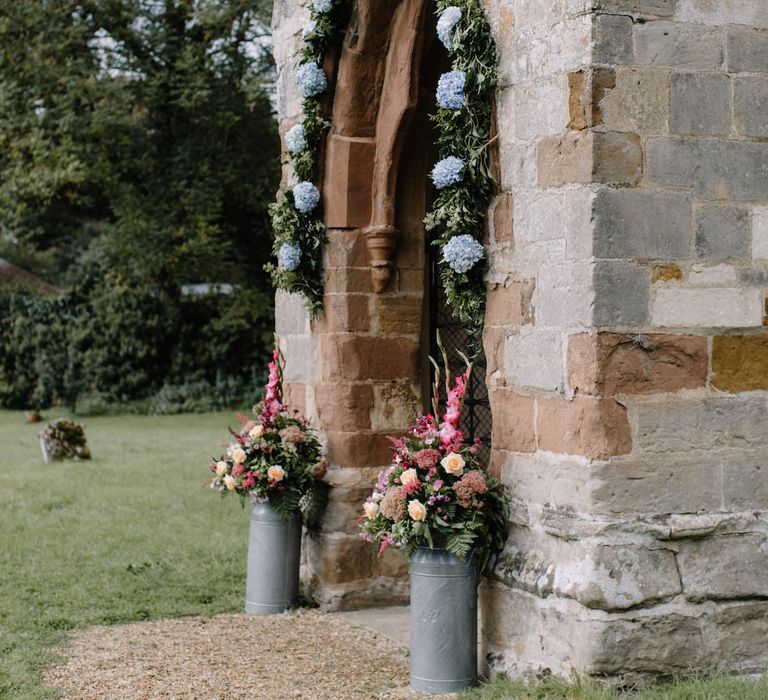 Church Floral Arch Entrance | Rural Wedding in a Sailcloth Tent on Stanford Hall Estate, Northamptonshire | Rebecca Goddard Photography