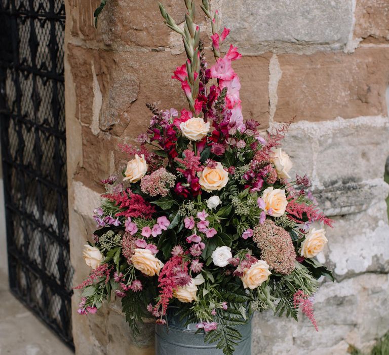 Deep Pink Milk Churn Wedding Flowers | Rural Wedding in a Sailcloth Tent on Stanford Hall Estate, Northamptonshire | Rebecca Goddard Photography