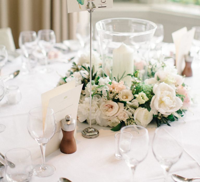 Hurricane Vase, Chuch Candle & Floral Centrepiece | Outdoor Pastel Country Garden Wedding at Barnsley House in Cirencester | M and J Photography | Motion Farm Wedding Films