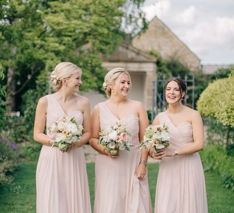 Bridesmaids in Blush Pink One Shoulder Dessy Bridesmaid Dresses | Outdoor Pastel Country Garden Wedding at Barnsley House in Cirencester | M and J Photography | Motion Farm Wedding Films