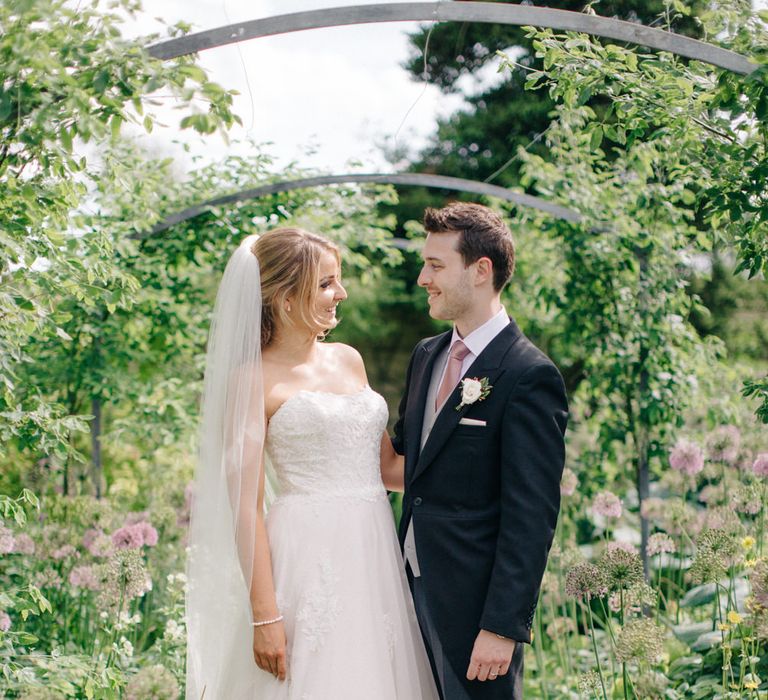 Bride in Lace Princess Gown | Groom in Traditional Morning Suit | Outdoor Pastel Country Garden Wedding at Barnsley House in Cirencester | M and J Photography | Motion Farm Wedding Films