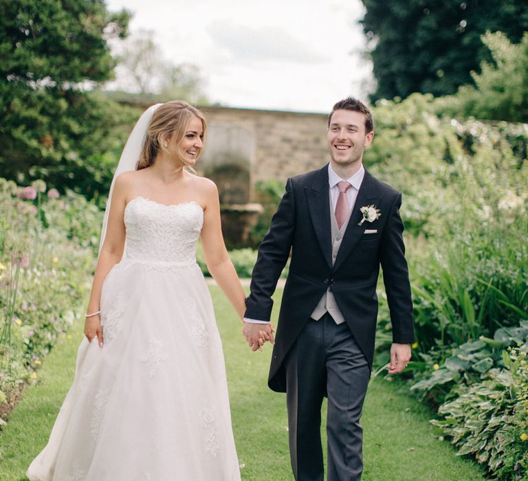 Bride in Lace Princess Gown | Groom in Traditional Morning Suit | Outdoor Pastel Country Garden Wedding at Barnsley House in Cirencester | M and J Photography | Motion Farm Wedding Films