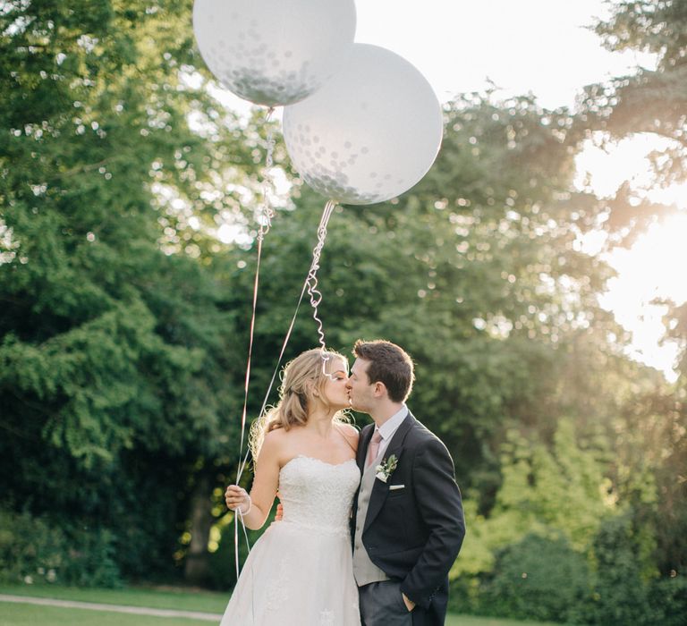 Giant Balloons | Bride in Lace Princess Gown | Groom in Traditional Morning Suit | Outdoor Pastel Country Garden Wedding at Barnsley House in Cirencester | M and J Photography | Motion Farm Wedding Films