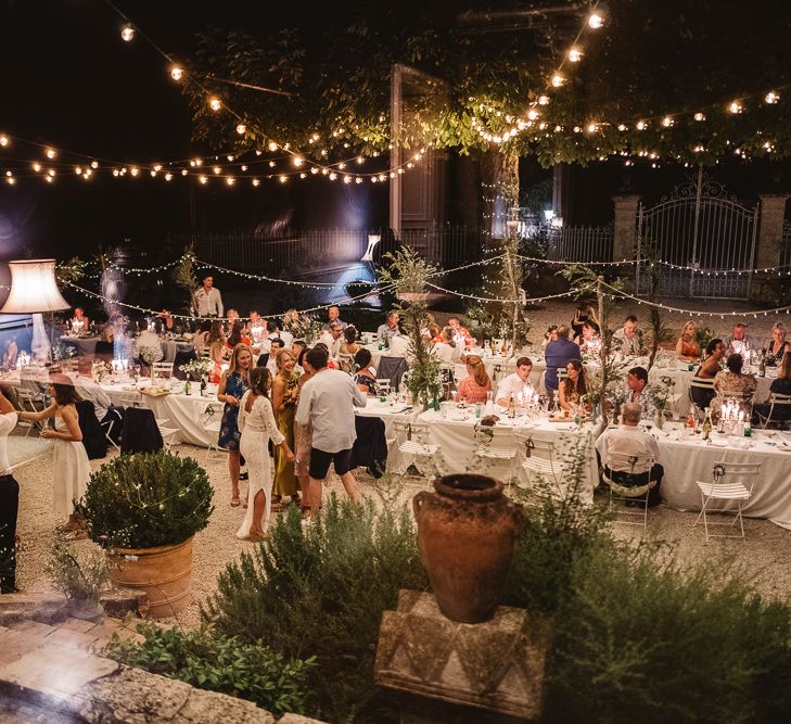 Fairy lit wedding in France at Chateau de Lartigolle. Photography by Derek Smietana