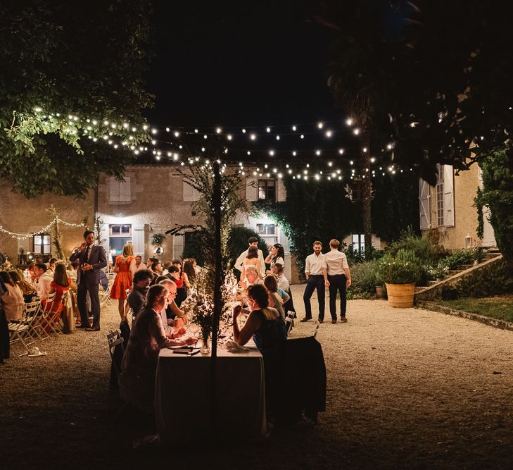 Fairy lit wedding in France at Chateau de Lartigolle. Photography by Derek Smietana