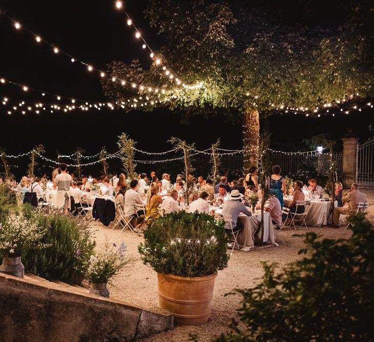 Fairy lit wedding in France at Chateau de Lartigolle. Photography by Derek Smietana