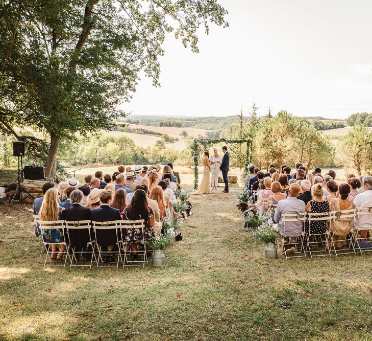 Idylic outdoor french wedding ceremony. Photography by Derek Smietana