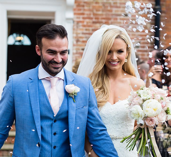 Bride in Pronovias Wedding Dress & Groom in Blue Hugo Boss Suit