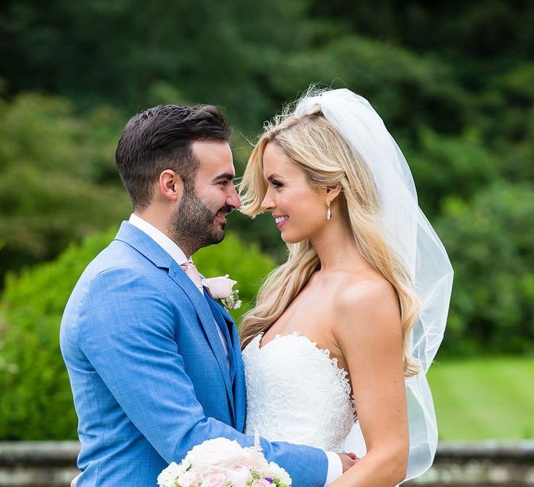 Bride in Pronovias Wedding Dress & Groom in Blue Hugo Boss Suit