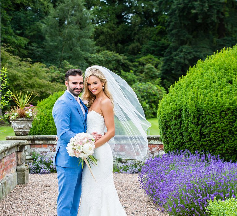 Bride in Pronovias Wedding Dress & Groom in Blue Hugo Boss Suit