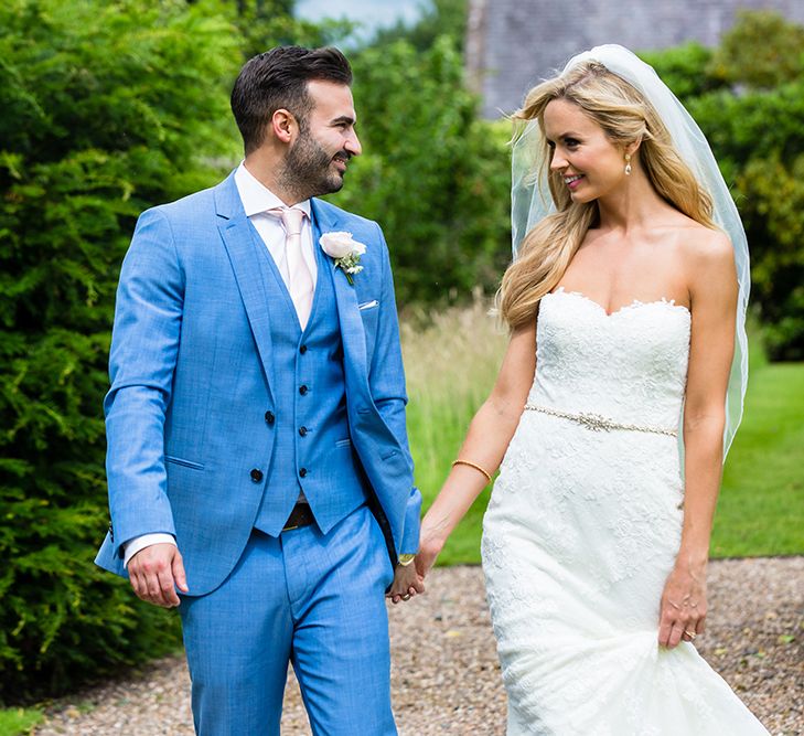 Bride in Pronovias Wedding Dress & Groom in Blue Hugo Boss Suit