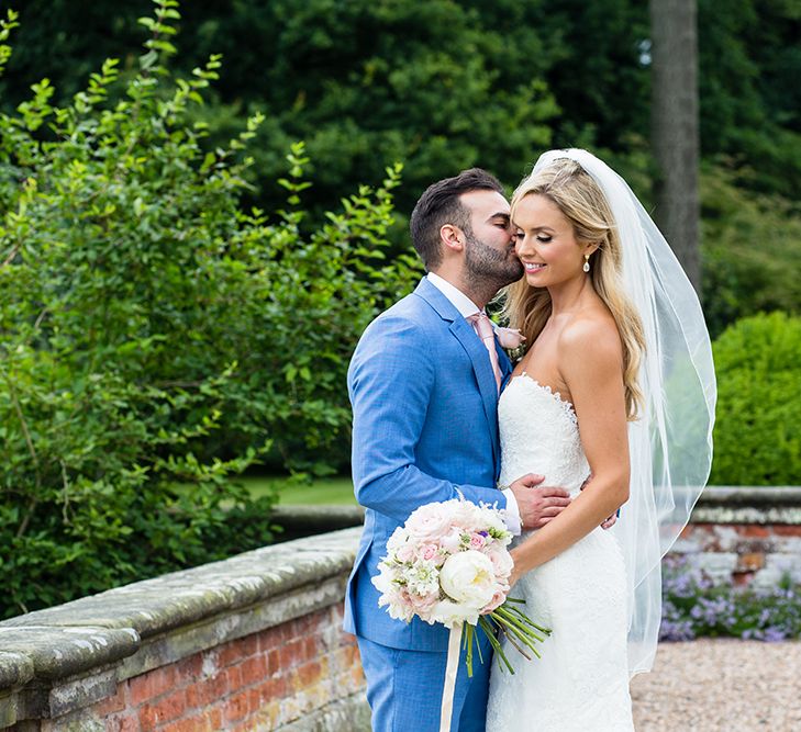 Bride in Pronovias Wedding Dress & Groom in Blue Hugo Boss Suit