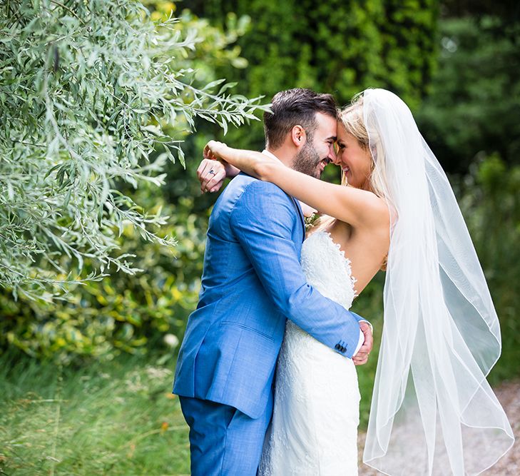 Bride in Pronovias Wedding Dress & Groom in Blue Hugo Boss Suit