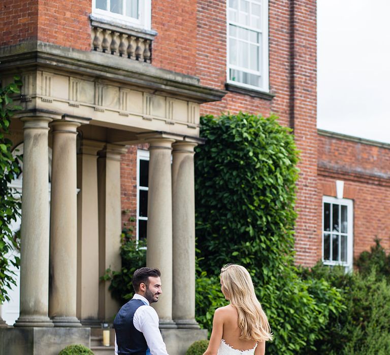 Bride in Pronovias Wedding Dress & Groom in Blue Hugo Boss Suit Outside Iscoyd Park in Shropshire