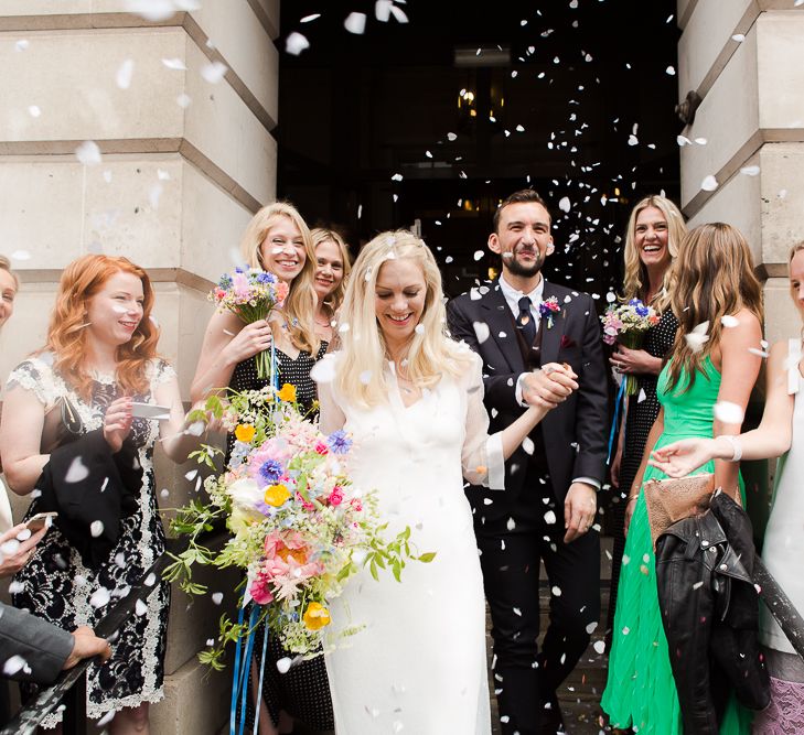 Confetti Moment at Camden Town Hall Wedding Ceremony with Bride in Charlie Brear Wedding Dress, Bright Bouquet & Groom in Paul Smith Suit