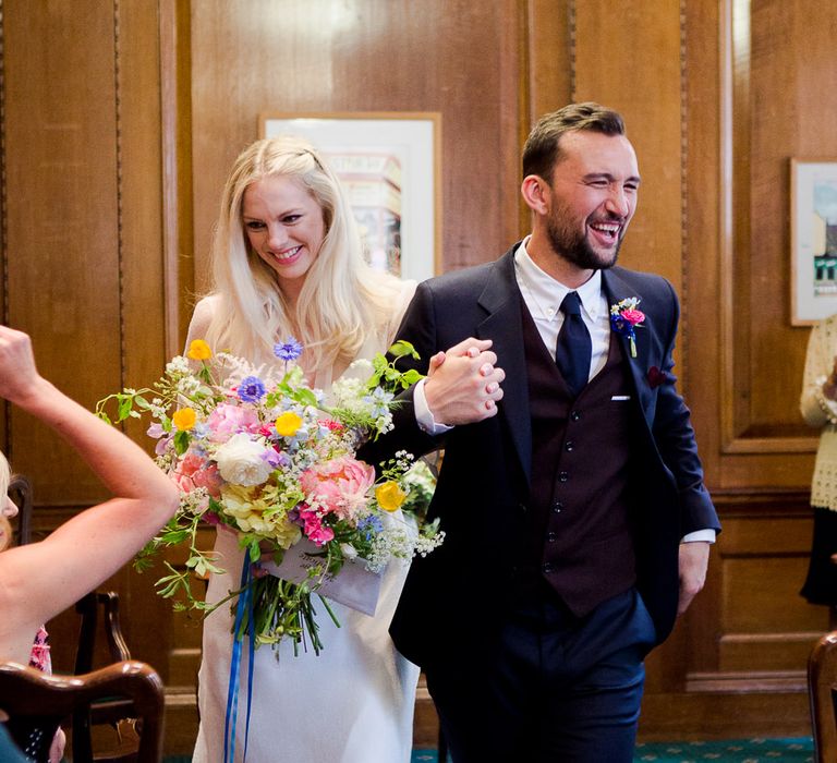 Camden Town Hall Wedding Ceremony with Bride in Charlie Brear Wedding Dress, Bright Bouquet & Groom in Paul Smith Suit