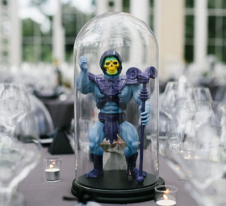 Iconic 80s Figure (Skeleton - He-Man) in Bell Jar Table Centrepiece Wedding Decor | Monochrome Wedding at Syon Park London | Chris Barber Photography | Second Shooter Beatrici Photography