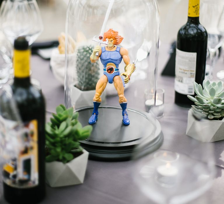 Iconic 80s Figure (Lion-o Thundercat) in Bell Jar Table Centrepiece Wedding Decor | Monochrome Wedding at Syon Park London | Chris Barber Photography | Second Shooter Beatrici Photography