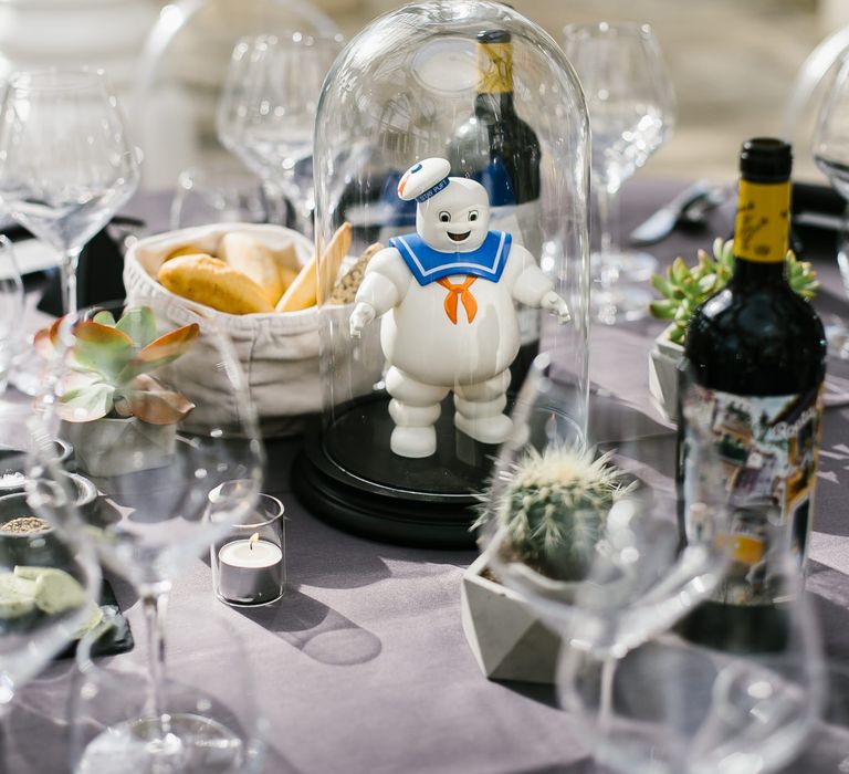 Iconic 80s Figure (Marshmallow Man - Ghostbusters) in Bell Jar Table Centrepiece Wedding Decor | Monochrome Wedding at Syon Park London | Chris Barber Photography | Second Shooter Beatrici Photography