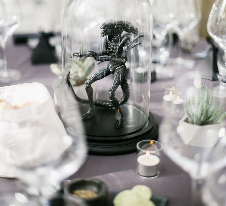 Iconic 80s Figure (Alien) in Bell Jar Table Centrepiece Wedding Decor | Monochrome Wedding at Syon Park London | Chris Barber Photography | Second Shooter Beatrici Photography