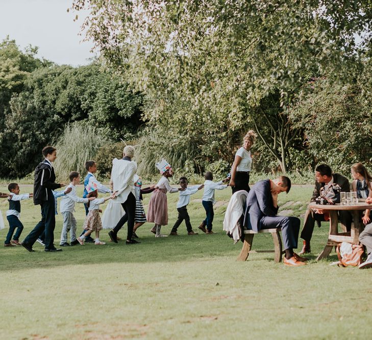 Hampton Court House Wedding With Pastel Flowers & White Hanging Lanterns With Children's Entertainment & Images From Joanna Nicole Photography