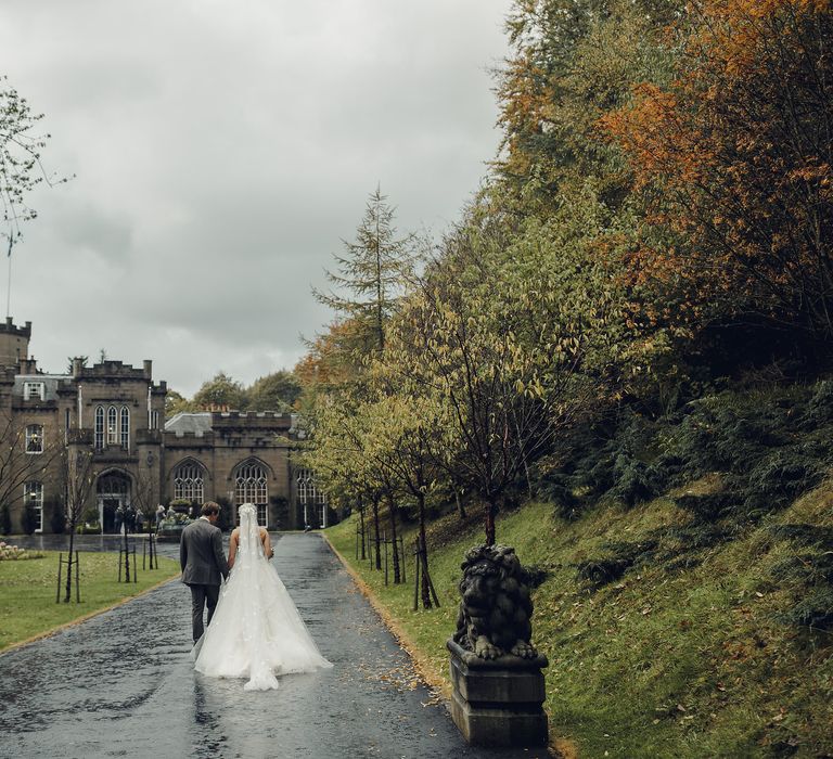 Bride in Bespoke Ian Stuart Gown with Detachable Tulle Skirt Outside Drumtochty Castle in Scotland