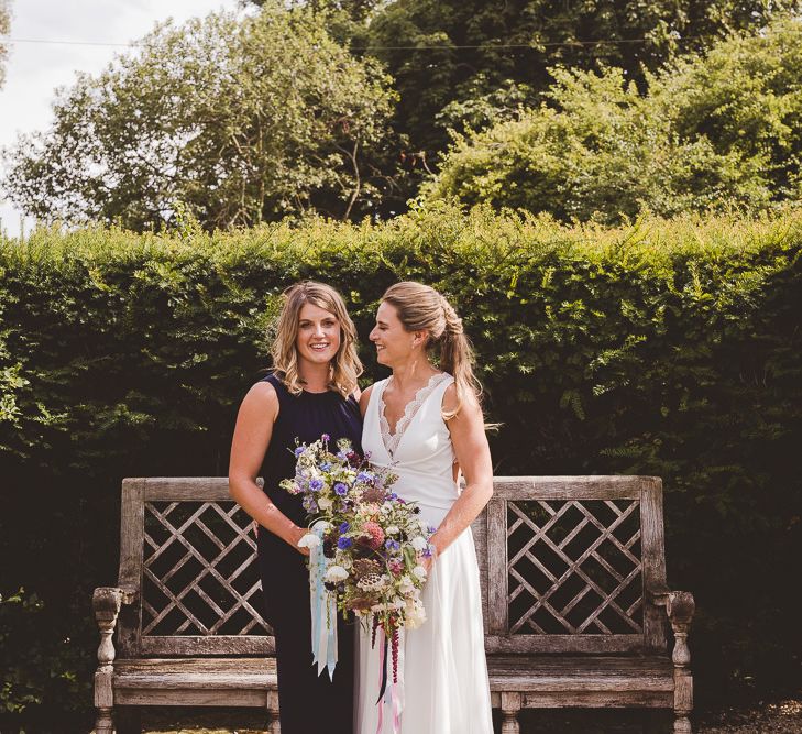 Bride in Charlie Brear Gown | Bridesmaid in Navy Phase Eight Dress | Outdoor Ceremony at Sulgrave Manor Northamptonshire | Nicola Casey Photography