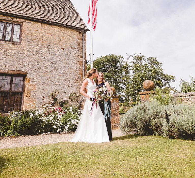 Bride in Charlie Brear Gown | Bridesmaid in Navy Phase Eight Dress | Outdoor Ceremony at Sulgrave Manor Northamptonshire | Nicola Casey Photography