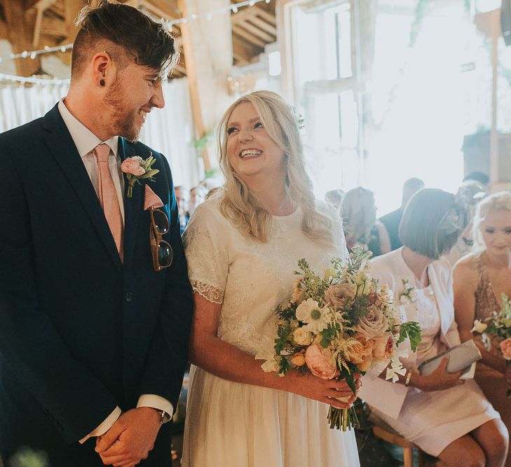 Wedding Ceremony | Bride in Custom Made Separates | Groom in Navy Next Suit & Pie Tie | Pink & Gold Summer Wedding at East Riddlesden Hall Barn, Wiltshire | Laura Calderwoods Photography