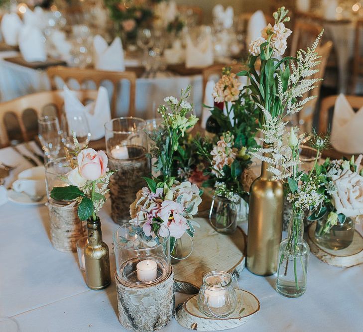 Tree Stumps, Candles & Flower Stems in Gold Spray Painted Bottles | Table Decor | Centrepiece | Pink & Gold Summer Wedding at East Riddlesden Hall Barn, Wiltshire | Laura Calderwoods Photography