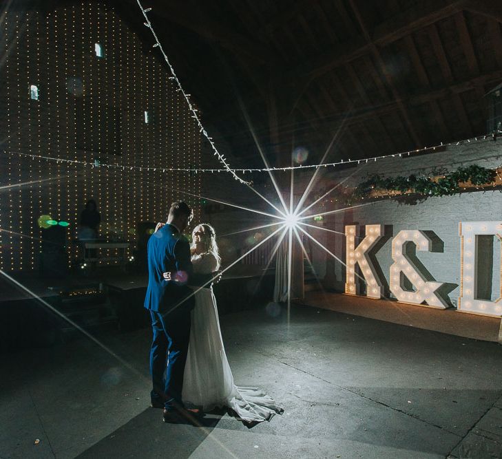 First Dance | Giant Light Up Letters | Fairy Lights | Portrait | Bride in Custom Made Separates | Groom in Next Suit | Pink & Gold Summer Wedding at East Riddlesden Hall Barn, Wiltshire | Laura Calderwoods Photography