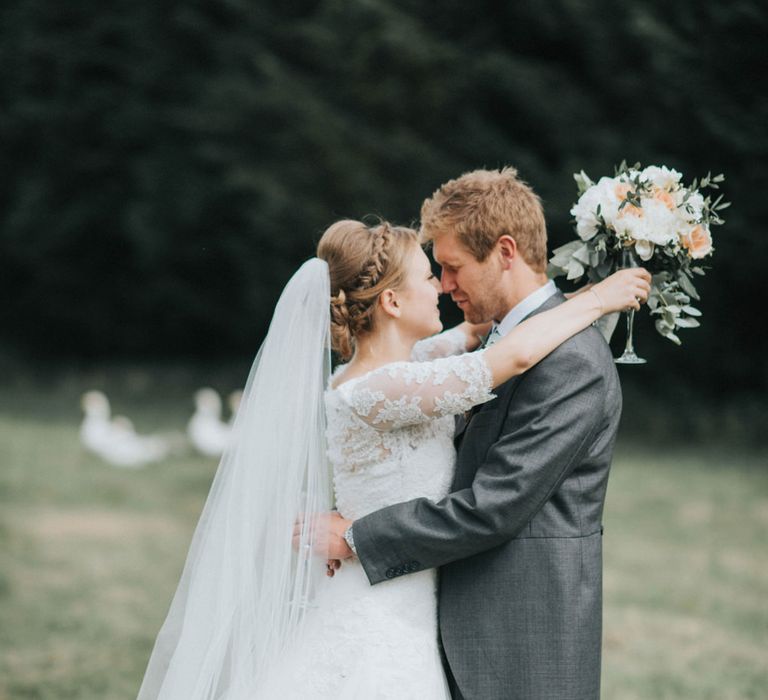 Bride in Pronovias White One Wedding Dress & Groom in Grey Morning Suit