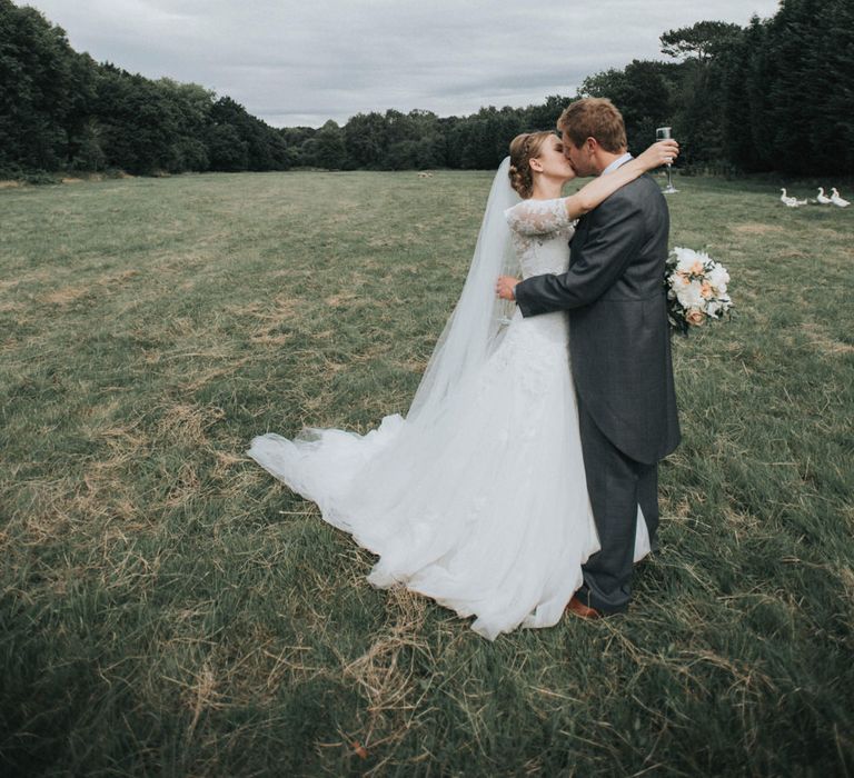 Bride in Pronovias White One Wedding Dress & Groom in Grey Morning Suit