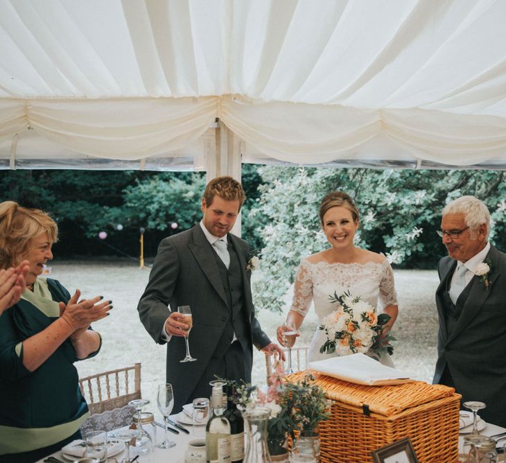 Bride in Pronovias White One Wedding Dress & Groom in Grey Morning Suit