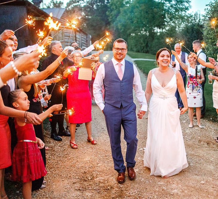 Sparkler Exit | Bride in Ellis Bridal Gown | Groom in Dyfed Menswear Navy Suit | Romantic Pastel Wedding at Cripps Barn | White Stag Wedding Photography | Dan Hodge Wedding Films