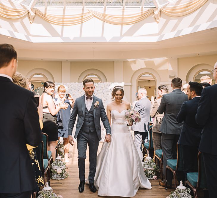 Wedding Ceremony | Bride in Ronald Joyce Wedding Dress | Groom in Grey Moss Bros Suit | The Orangery Maidstone | Lucie Watson Photography | TDH Media Films