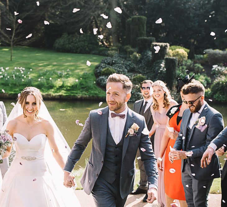 Confetti | Bride in Ronald Joyce Wedding Dress | Groom in Grey Moss Bros Suit | The Orangery Maidstone | Lucie Watson Photography | TDH Media Films