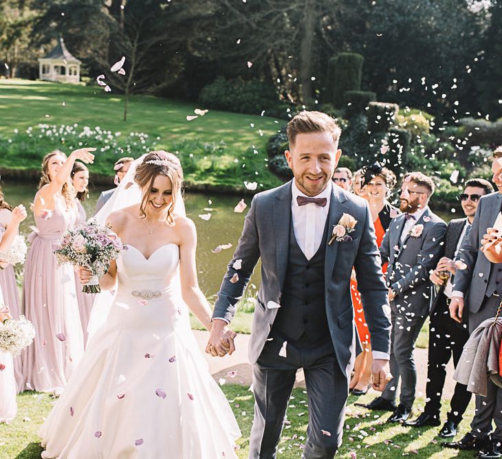 Confetti | Bride in Ronald Joyce Wedding Dress | Groom in Grey Moss Bros Suit | The Orangery Maidstone | Lucie Watson Photography | TDH Media Films