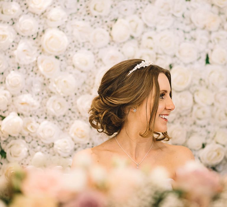 Bride at Top Table Flower Back Drop | The Orangery Maidstone | Lucie Watson Photography | TDH Media Films