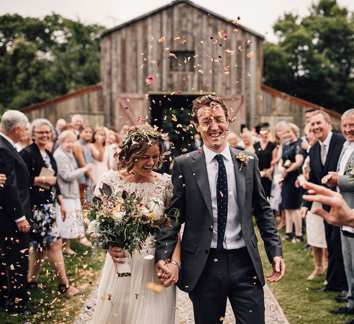 Confetti Exit | Bride in Catherine Deane Gown | Groom in Grey Edit Suits Suit | Rustic Barn Wedding at Nancarrow Farm, Cornwall | Samuel Docker Photography