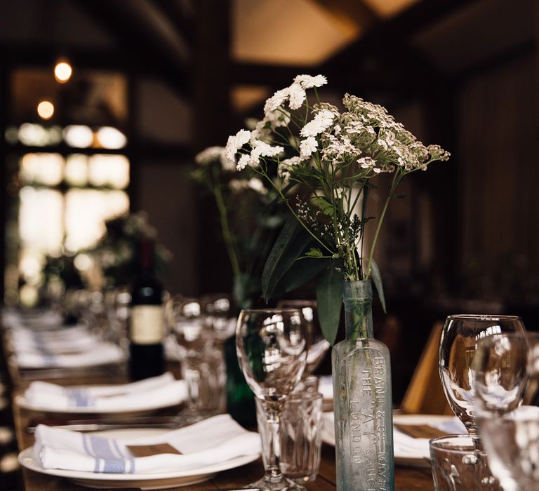 Flower Stems in Bottles | Rustic Barn Wedding at Nancarrow Farm, Cornwall | Samuel Docker Photography