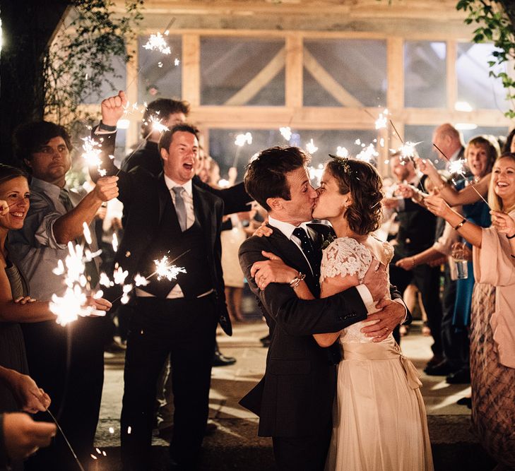 Sparkler Exit | Bride in Catherine Deane Gown | Groom in Grey Edit Suits Suit | Rustic Barn Wedding at Nancarrow Farm, Cornwall | Samuel Docker Photography