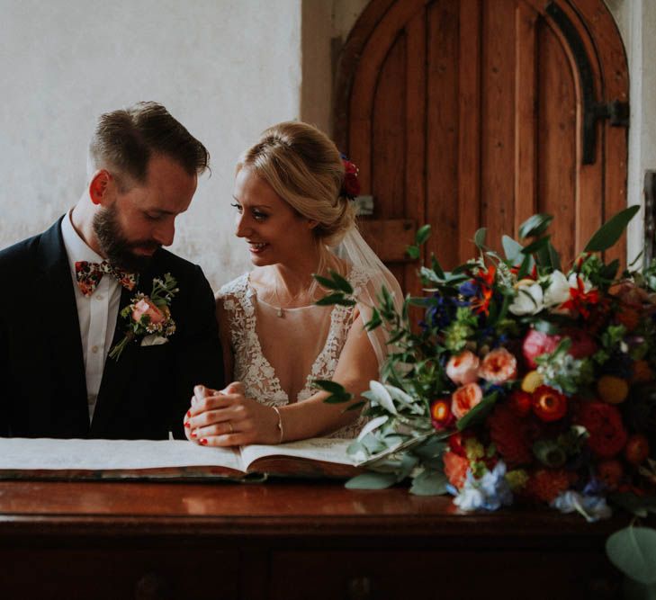 Church Wedding Ceremony | Bride in Lace & Tulle Gown | Groom in Black Suit & Liberty Print Bow Tie | Colourful DIY Barn Wedding at The Manor Barn, Cambridge | Meghan Lorna Photography