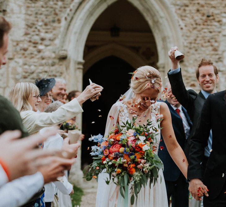 Confetti Exit | Bride in Lace & Tulle Gown | Groom in Black Suit & Liberty Print Bow Tie | Colourful DIY Barn Wedding at The Manor Barn, Cambridge | Meghan Lorna Photography